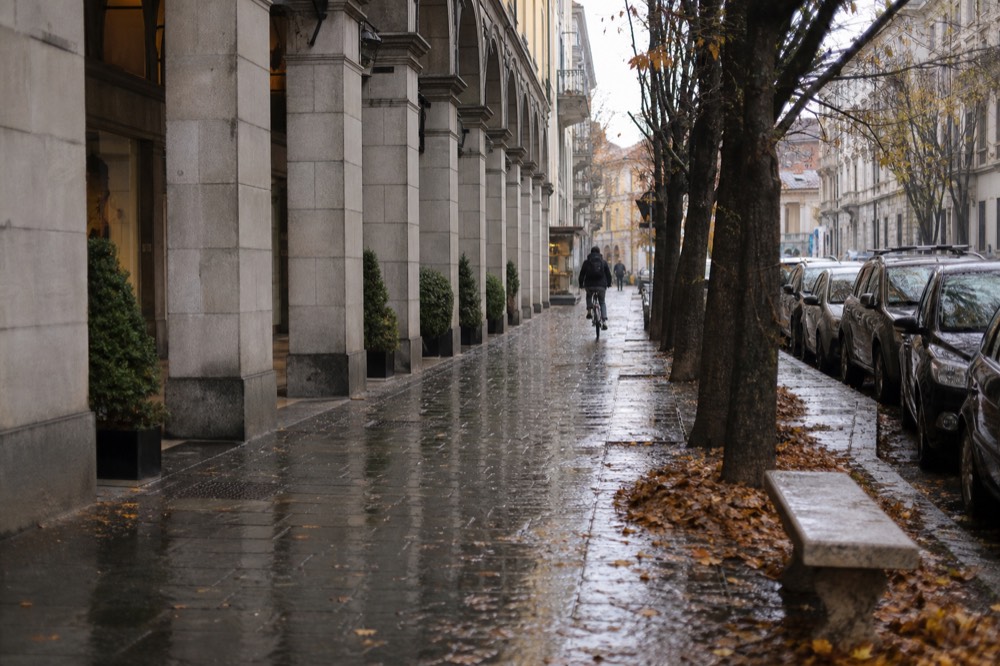 Turin's porticoed shopping streets under warm autumn light.