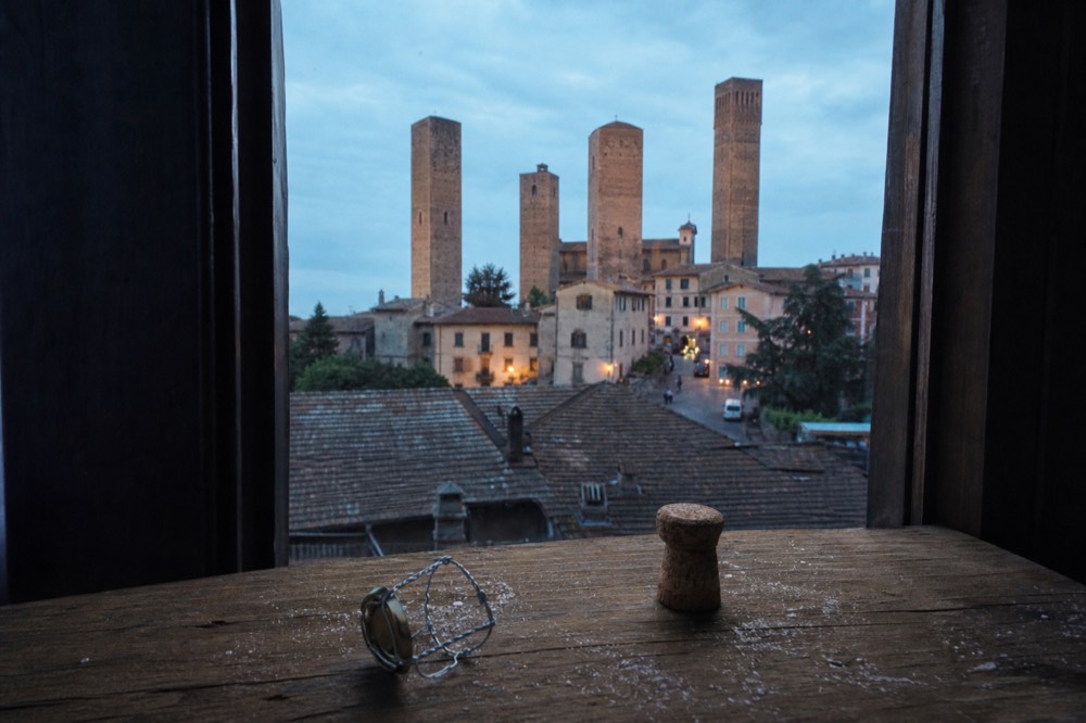 A cork and muselet from a bottle of sparkling wine on a cellar table.