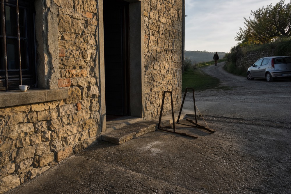 Row of e-bikes parked outside a stone cellar door.