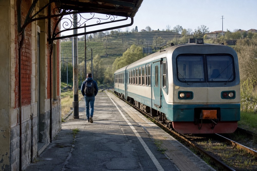 Regional train at a small station platform in the Piedmont countryside.