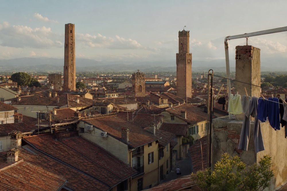 Alba's medieval towers rising above terracotta rooftops.
