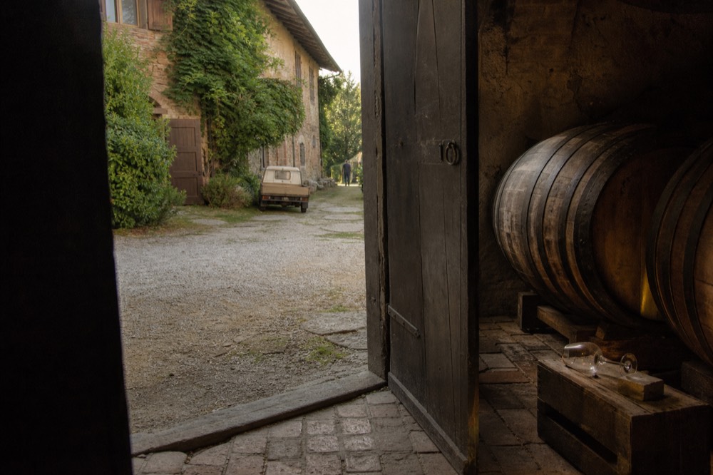 Wine cellar door with barrels visible.