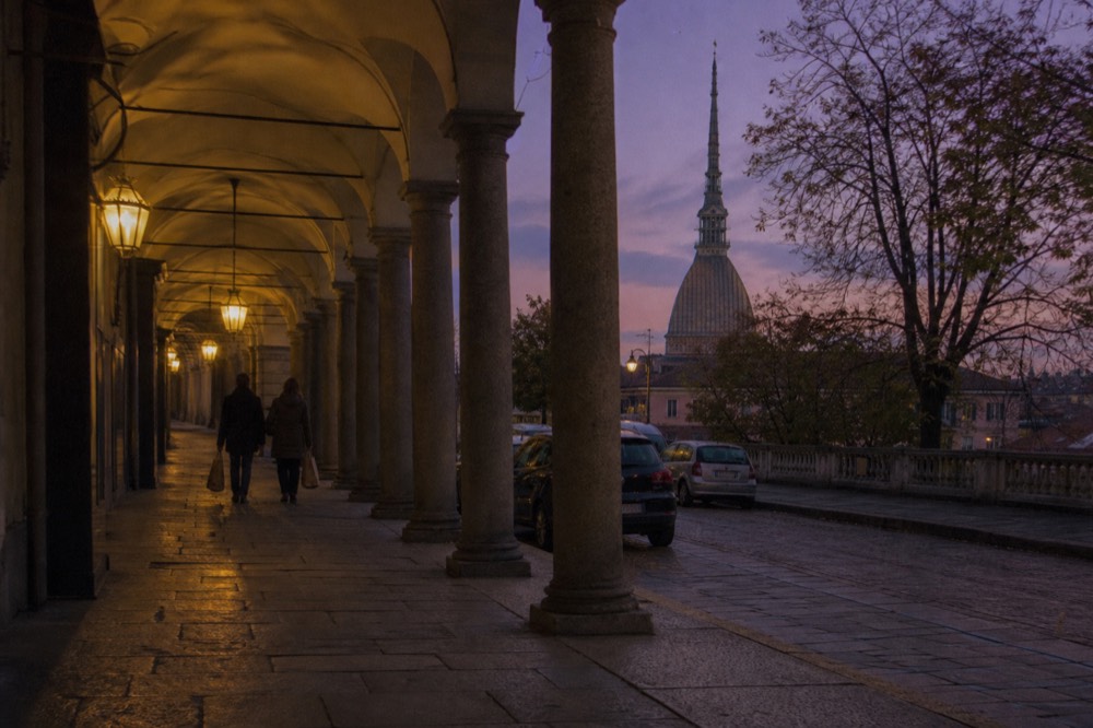 Turin arcaded street with the Mole Antonelliana in the distance.