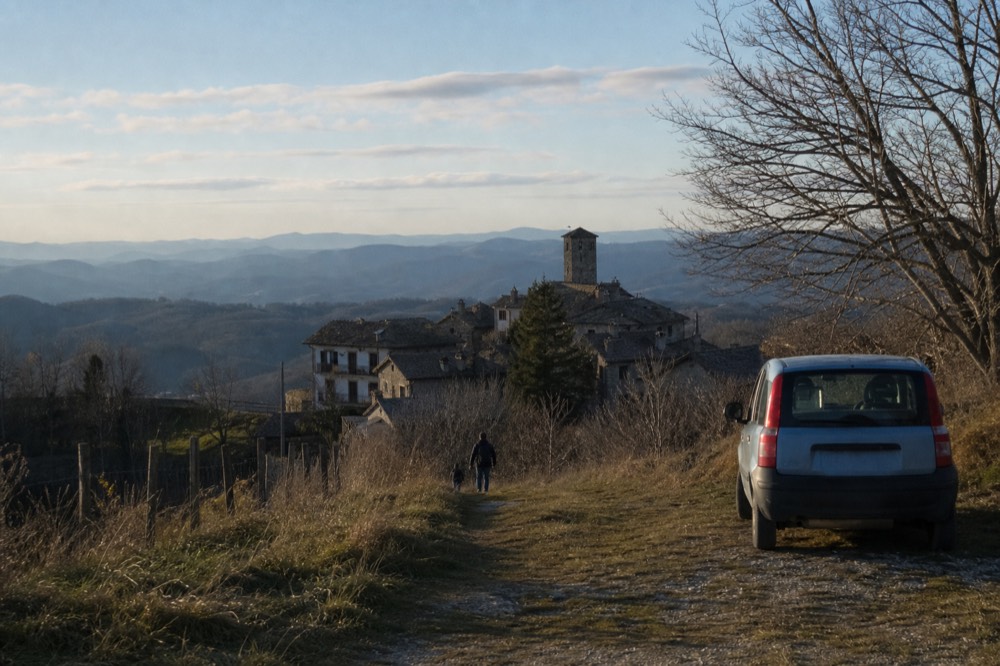Alta Langa hilltop village with wooded ridges fading into distance.